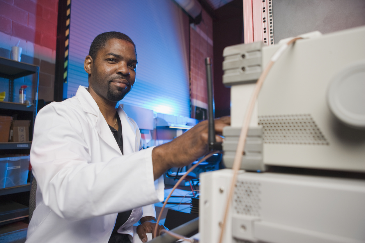Photo of African American man testing lab equipment.